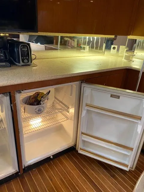 Slide: The Image of 2003 Viking 50 Open yacht kitchen with open fridge and countertop appliances. - 31