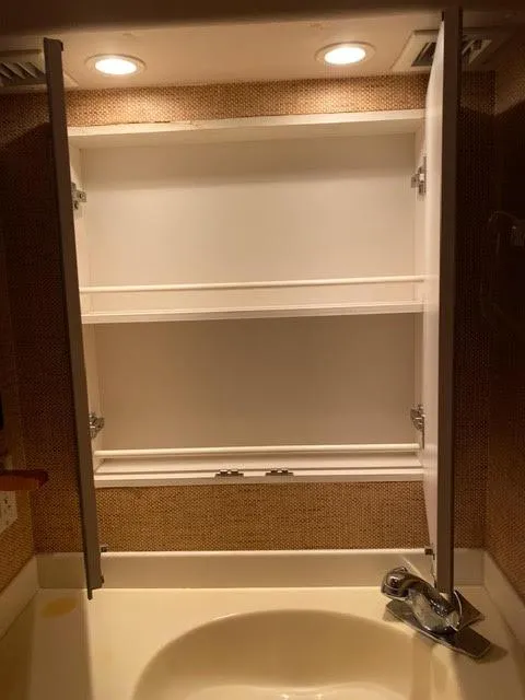 Slide: The Image of Open medicine cabinet in 2003 Viking 50 Open yacht bathroom. - 32