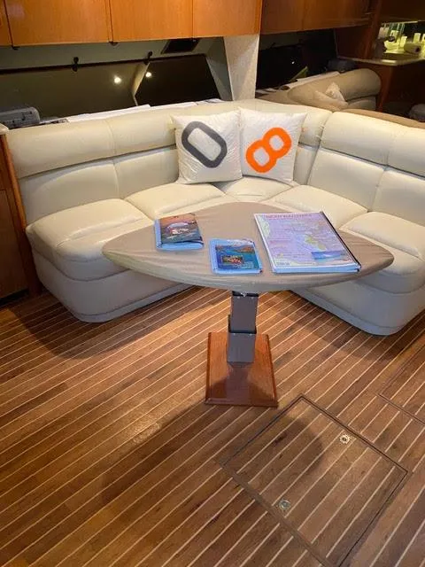 Slide: The Image of 2003 Viking 50 Open yacht interior with white leather seating and wooden table. - 34