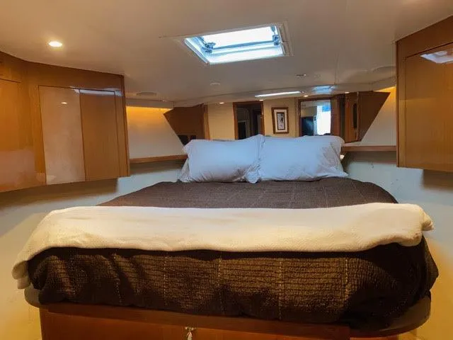 Slide: The Image of 2003 Viking 50 Open yacht bedroom with skylight and wooden cabinetry. - 37