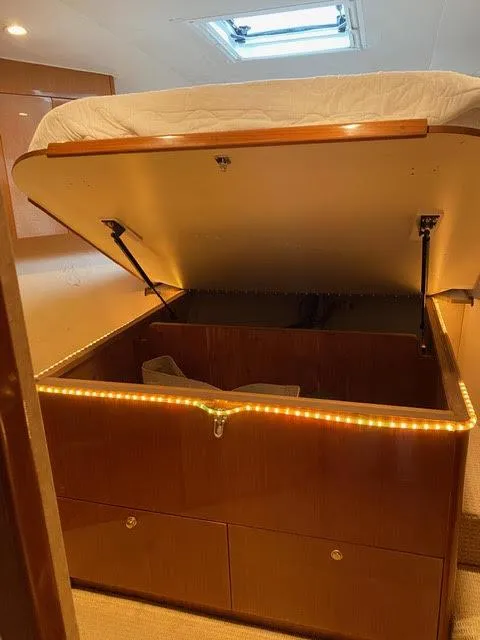 Slide: The Image of Under-bed storage compartment in a 2003 Viking 50 Open yacht. - 38