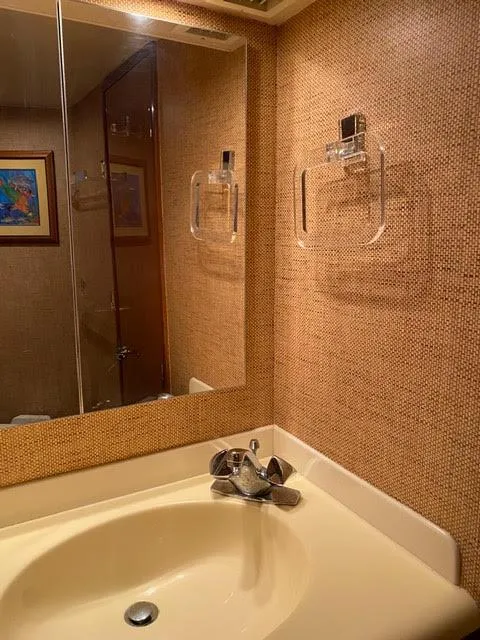 Slide: The Image of 2003 Viking 50 Open yacht bathroom with beige sink and mirror. - 40