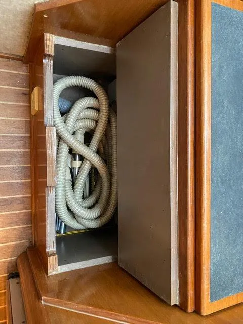 Slide: The Image of Coiled hose stored in a compartment on a 2003 Viking 50 Open yacht. - 45