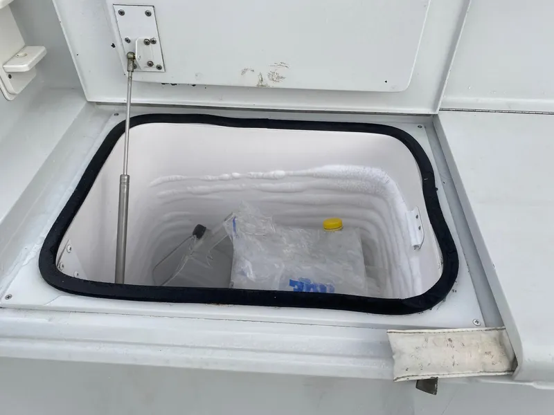 Slide: The Image of 2003 Viking 50 Open boat storage compartment with ice and a plastic bottle. - 5