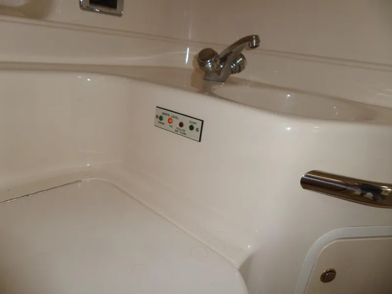 Slide: The Image of Close-up of a white boat bathroom with fixtures and controls. - 54