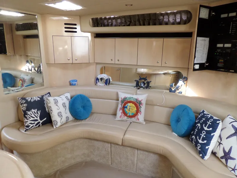 Slide: The Image of Interior of the 2003 Sea Ray 380 Sundancer with curved leather sofa and decorative pillows. - 50
