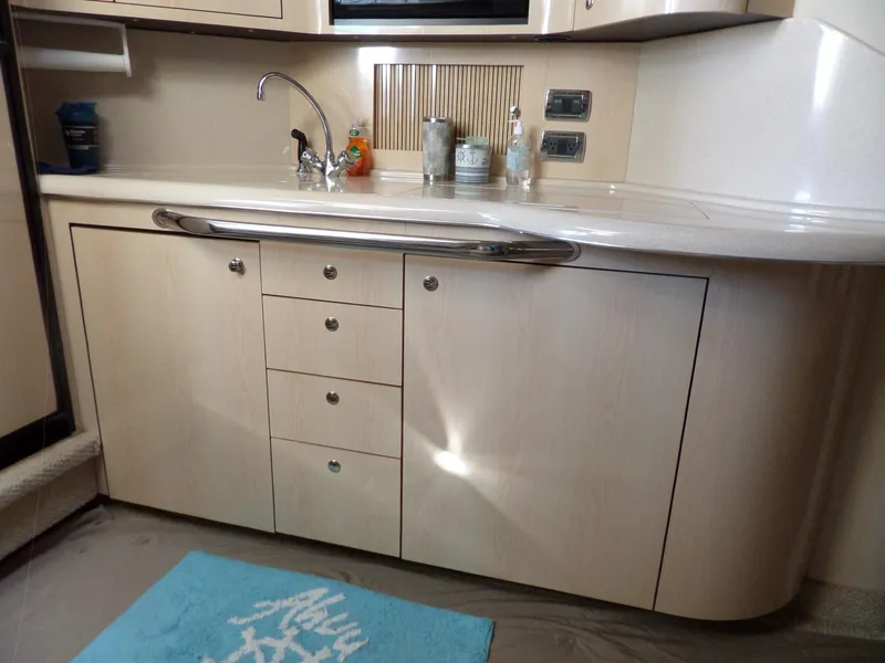 Slide: The Image of The galley of a 2003 Sea Ray 380 Sundancer with light wood and stainless steel fixtures. - 31