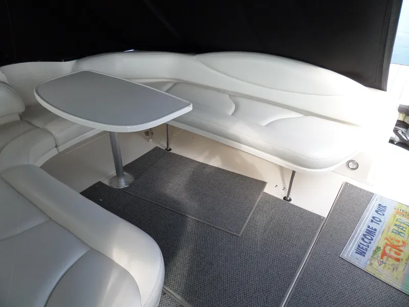 Slide: The Image of Interior of the 2003 Sea Ray 380 Sundancer with white seating and a table. - 4