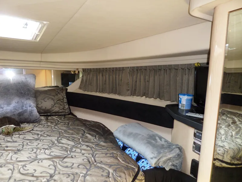 Slide: The Image of Cabin of the 2003 Sea Ray 380 Sundancer with a cozy bed and elegant curtains. - 46