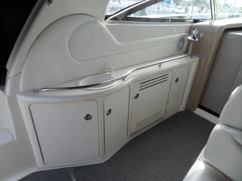 Slide: The Image of Interior of a 2003 Sea Ray 380 Sundancer with white cabinets and gray carpet. - 7