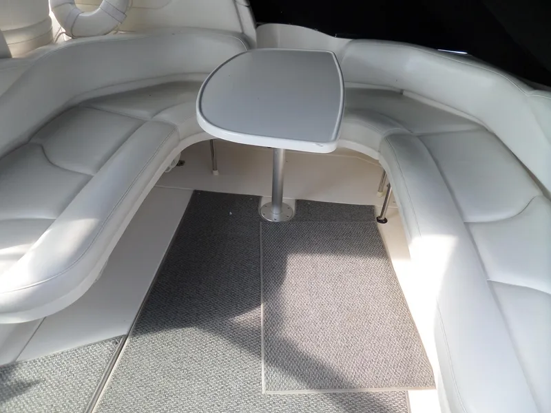 Slide: The Image of The 2003 Sea Ray 380 Sundancer features an elegant white seating area with a central table. - 6
