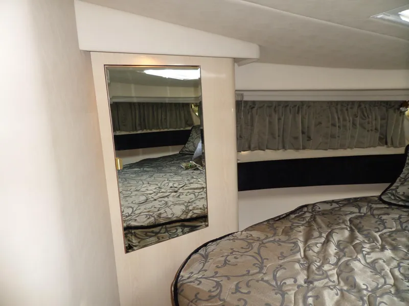 Slide: The Image of Interior of a 2003 Sea Ray 380 Sundancer featuring an elegant bed and a mirror. - 43