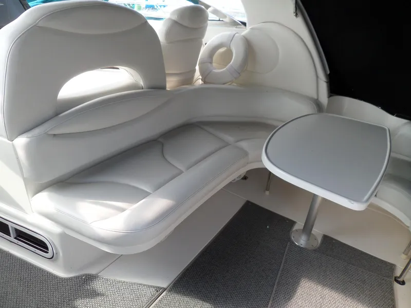 Slide: The Image of The 2003 Sea Ray 380 Sundancer features an elegant white leather seating area with a small table. - 5