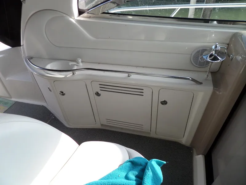 Slide: The Image of Interior of a 2003 Sea Ray 380 Sundancer with white cabinets and a handrail. - 21