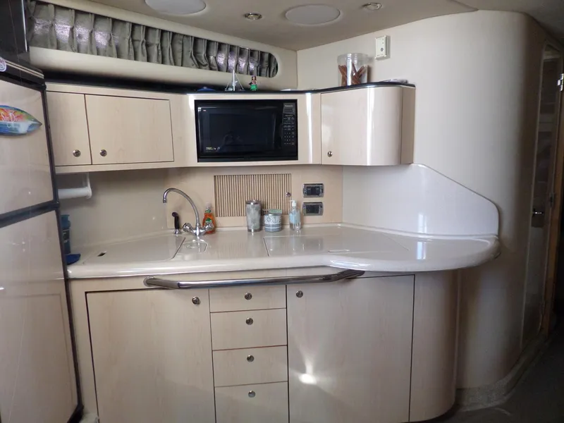 Slide: The Image of Galley of the 2003 Sea Ray 380 Sundancer with sink, microwave, and cabinets. - 39