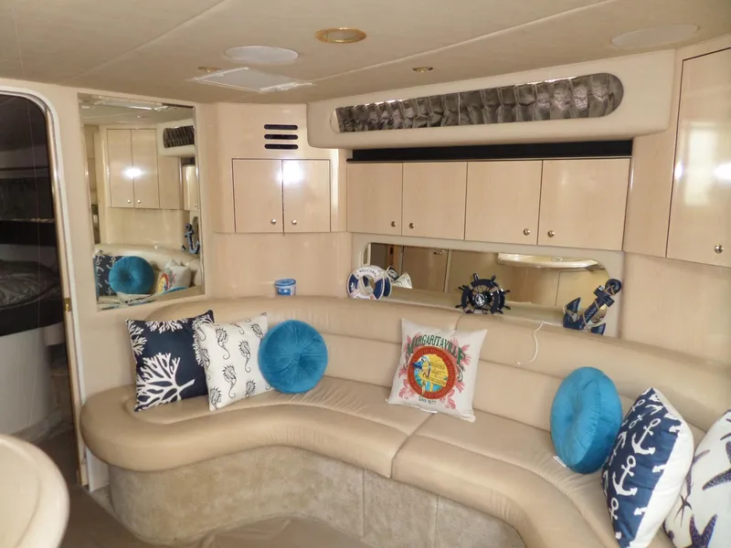 Slide: The Image of Interior of the 2003 Sea Ray 380 Sundancer with beige sofa and decorative pillows. - 24