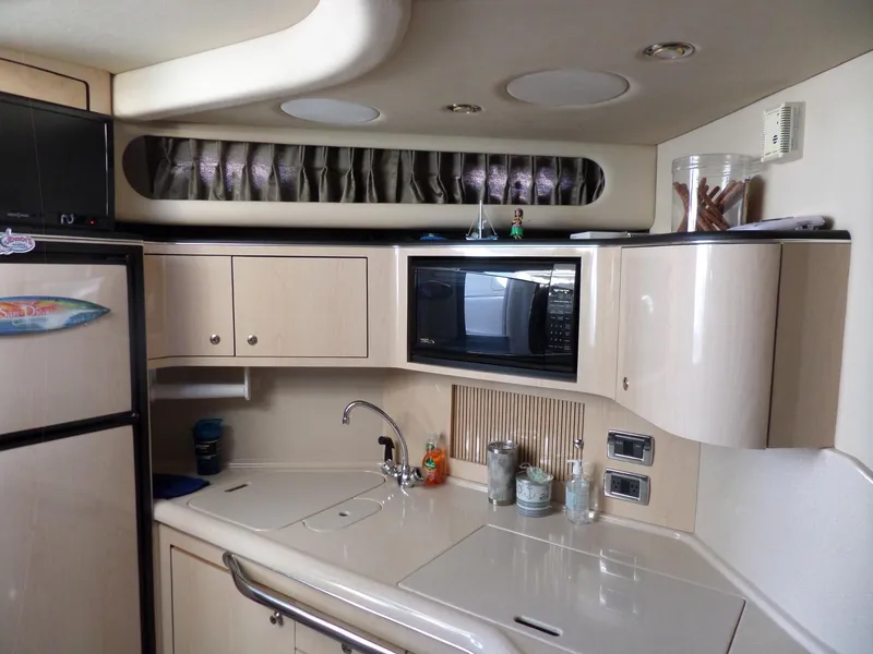 Slide: The Image of Galley of the 2003 Sea Ray 380 Sundancer with microwave, refrigerator, and cabinets. - 30