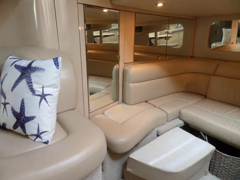 Slide: The Image of Interior of the 2003 Sea Ray 380 Sundancer with beige upholstery and a starfish-patterned pillow. - 37