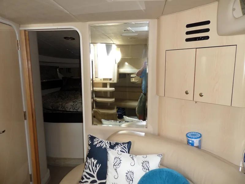 Slide: The Image of Interior of the 2003 Sea Ray 380 Sundancer with beige sofa and decorative pillows. - 34