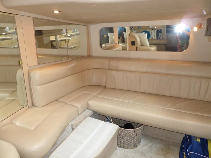Slide: The Image of Interior of the 2003 Sea Ray 380 Sundancer with beige leather sofa and mirrors. - 36