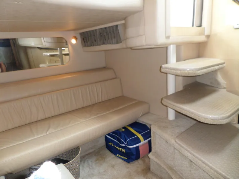 Slide: The Image of Interior of a 2003 Sea Ray 380 Sundancer with leather sofa and stairs. - 38