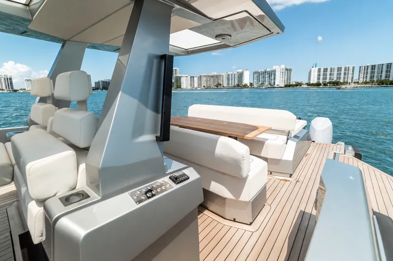Slide: The Image of Luxurious 2021 Wally wallytender48X yacht with sleek design and waterfront cityscape view. - 14