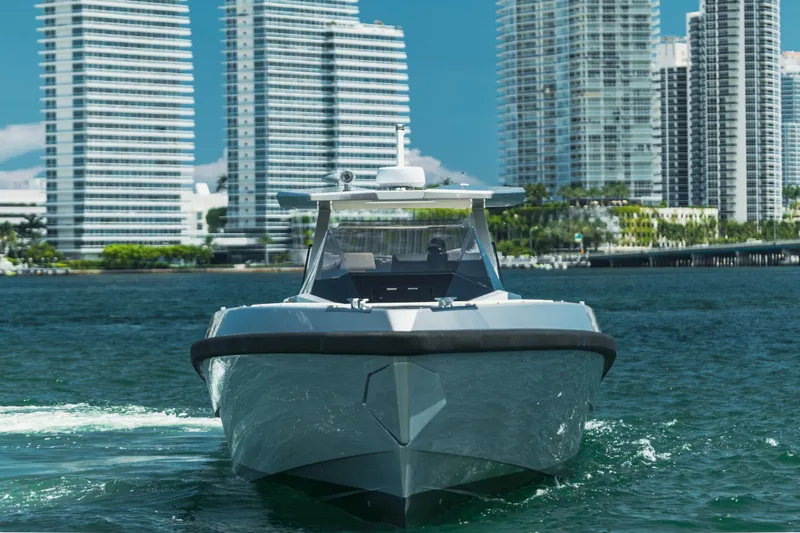 Slide: The Image of 2021 Wally 48 WALLYTENDER X luxury yacht cruising near modern city skyline. - 2