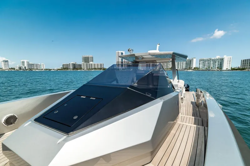 Slide: The Image of 2021 Wally 48 WALLYTENDER X luxury yacht on calm waters with city skyline. - 5