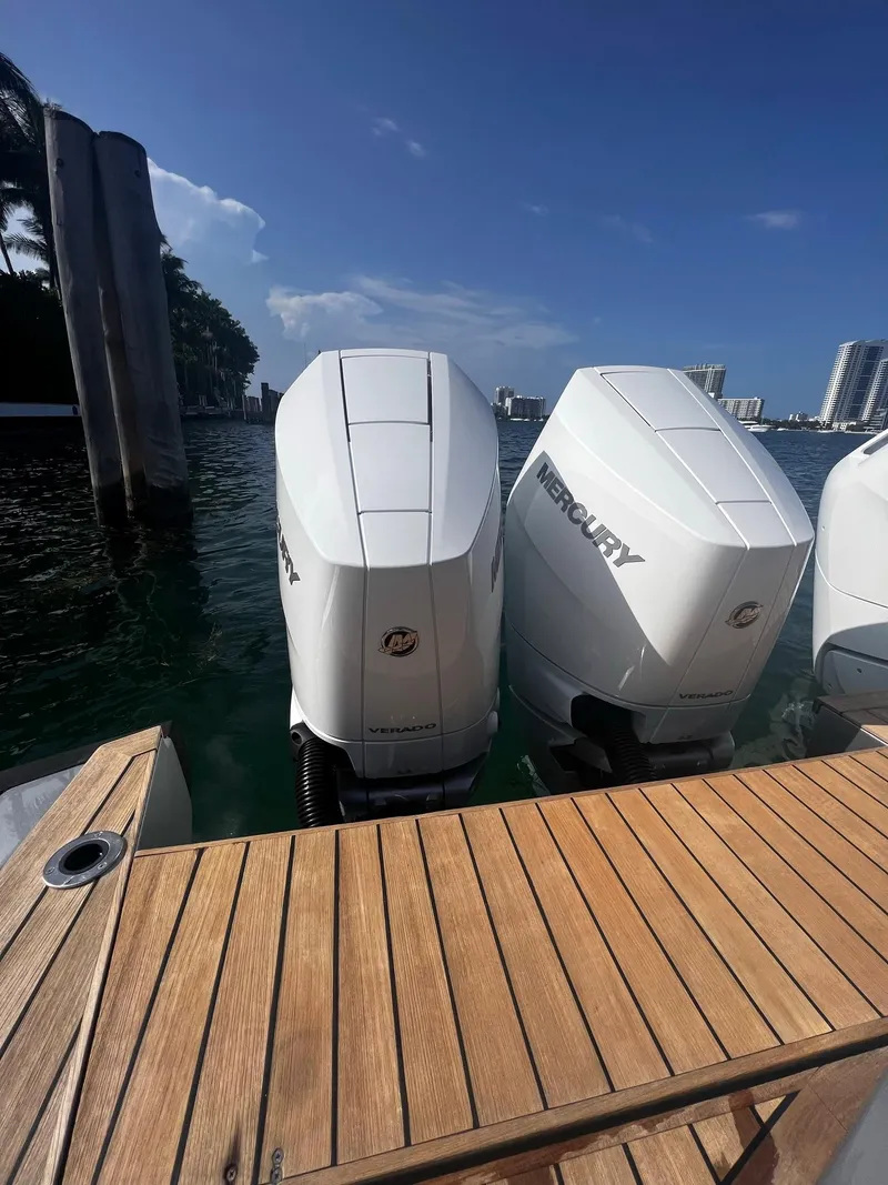 Slide: The Image of 2021 Wally 48 WALLYTENDER X with Mercury outboard engines docked by wooden deck. - 30