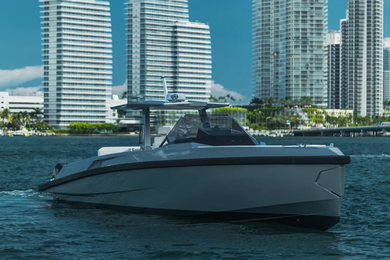 Slide: The Image of 2021 Wally 48 WALLYTENDER X luxury yacht cruising near modern city skyline. - 1