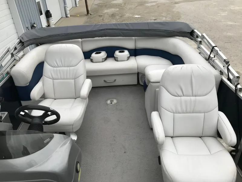 Slide: The Image of 2015 Palm Beach Ultra Sport 220 boat interior with white leather seating and steering wheel. - 13
