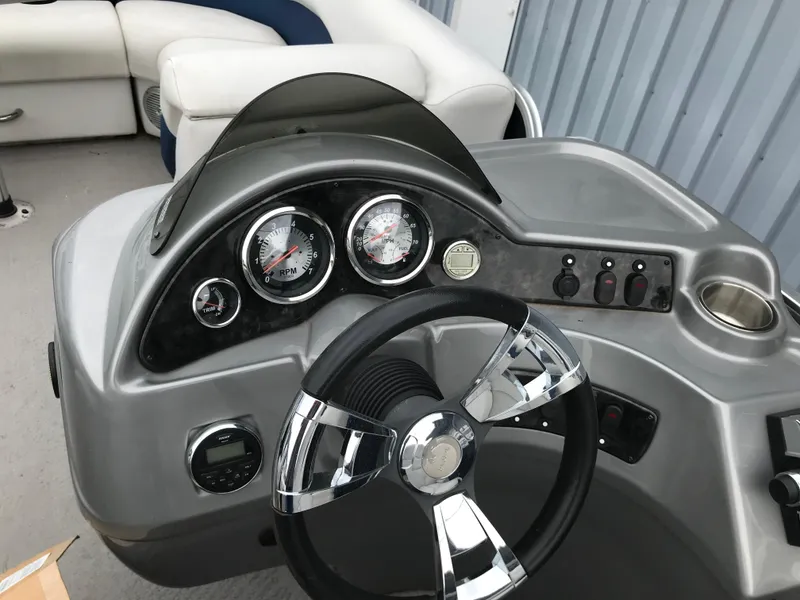 Slide: The Image of 2015 Palm Beach Ultra Sport 220 dashboard with steering wheel and gauges. - 17