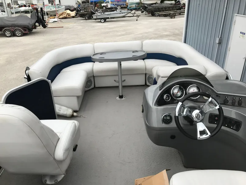 Slide: The Image of 2015 Palm Beach Ultra Sport 220 boat interior with seating and steering console. - 19