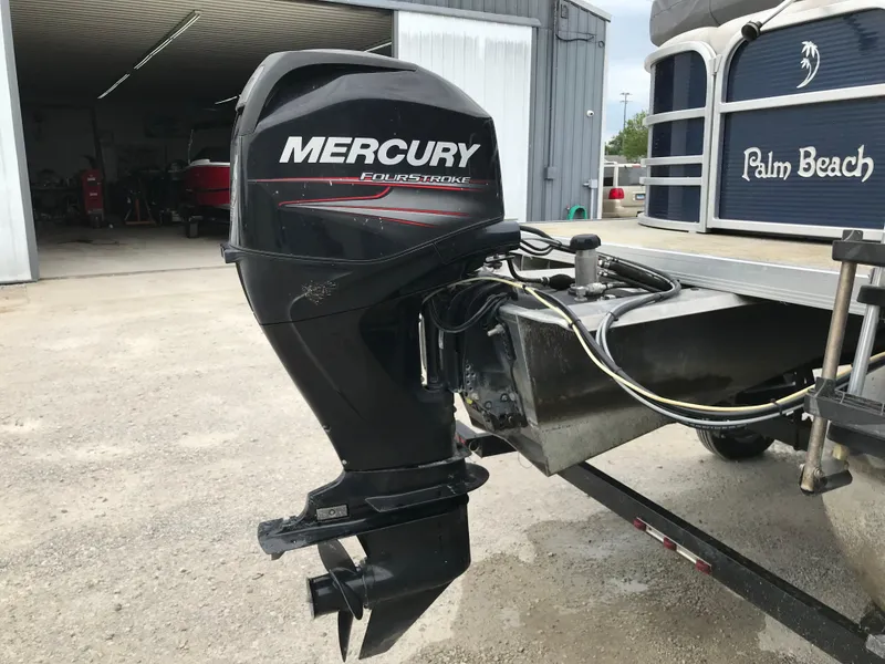 Slide: The Image of Mercury FourStroke engine on 2015 Palm Beach Ultra Sport 220 boat, parked outdoors. - 4