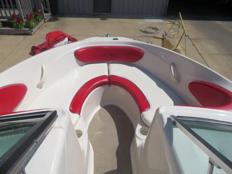 Slide: The Image of 2006 Sea Ray 205 Sport boat with red and white seating in the bow area. - 5