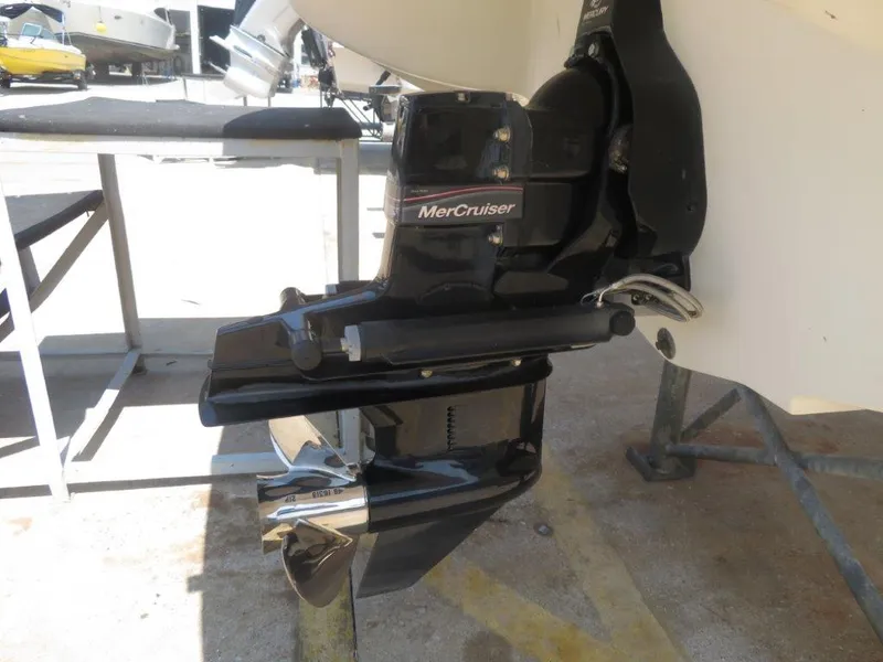 Slide: The Image of MerCruiser engine on a 2006 Sea Ray 205 Sport boat, docked outdoors. - 9