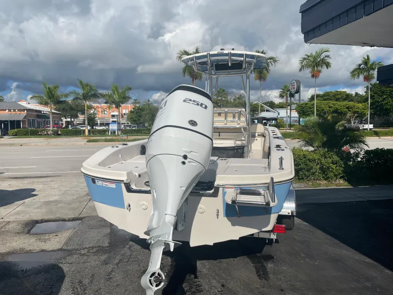 Slide: The Image of 2024 Carolina Skiff 26 Ultra Elite boat with powerful outboard motor, parked outdoors. - 13