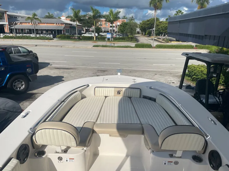 Slide: The Image of 2024 Carolina Skiff 26 Ultra Elite boat with spacious seating, parked near a road. - 15