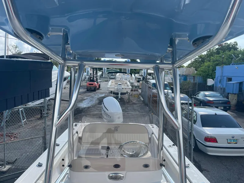 Slide: The Image of 2024 Carolina Skiff 26 Ultra Elite boat in a marina with surrounding vehicles. - 16