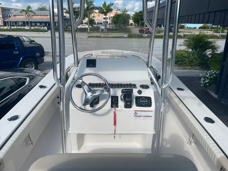 Slide: The Image of 2024 Carolina Skiff 26 Ultra Elite boat console with steering wheel and controls. - 17