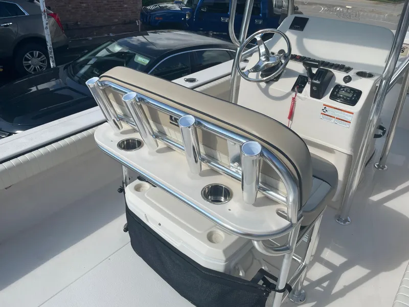 Slide: The Image of 2024 Carolina Skiff 26 Ultra Elite boat interior with steering console and rod holders. - 18