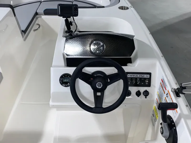 Slide: The Image of 2024 Bayliner Element M17 boat dashboard with steering wheel and control panel. - 5