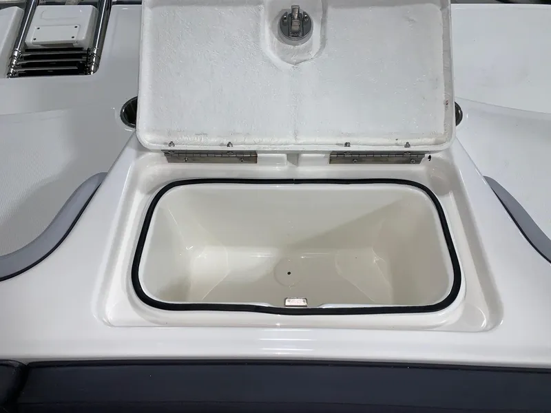 Slide: The Image of Open storage compartment on a 2024 Bayliner Element M17 boat. - 7