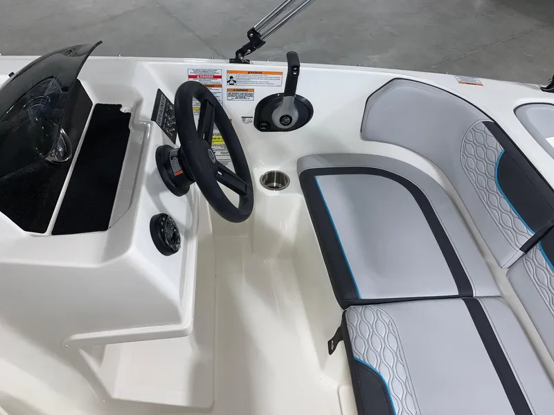 Slide: The Image of 2024 Bayliner Element M17 boat interior with steering wheel and seating. - 9