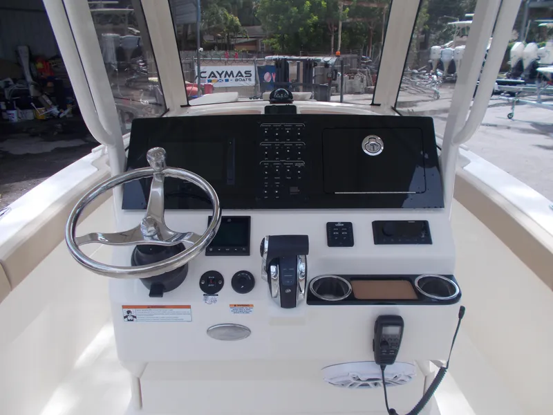 Slide: The Image of 2025 Scout 240 XSF boat dashboard with steering wheel and control panel. - 1