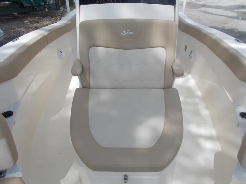 Slide: The Image of 2025 Scout 240 XSF boat interior seating with beige and white upholstery. - 12