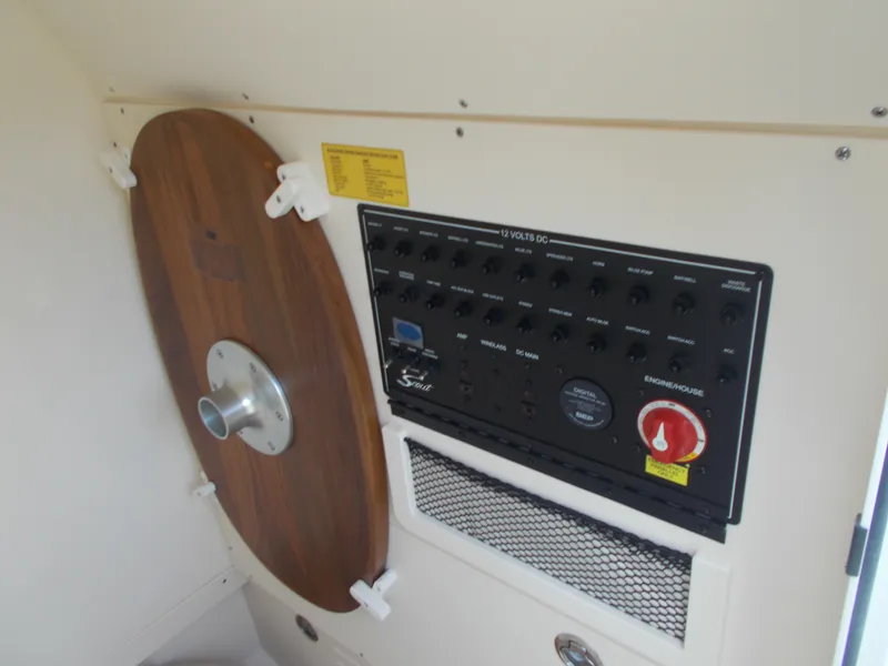Slide: The Image of Control panel and wooden table mount inside a 2025 Scout 240 XSF boat. - 15