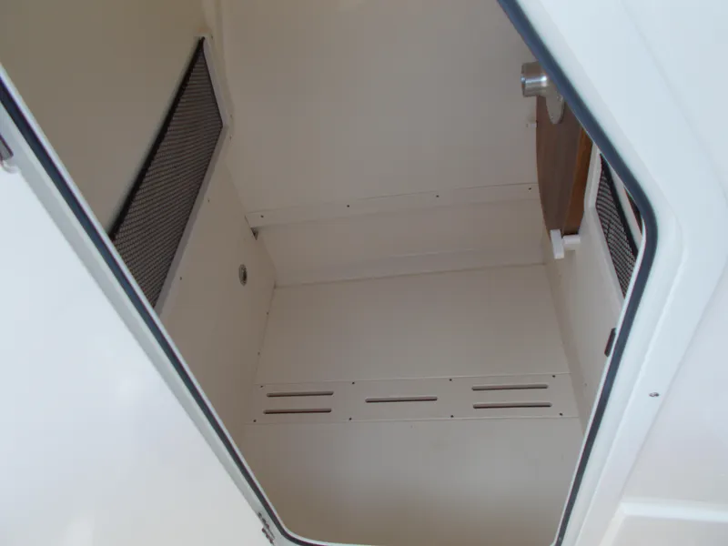 Slide: The Image of 2025 Scout 240 XSF boat interior storage compartment - 17