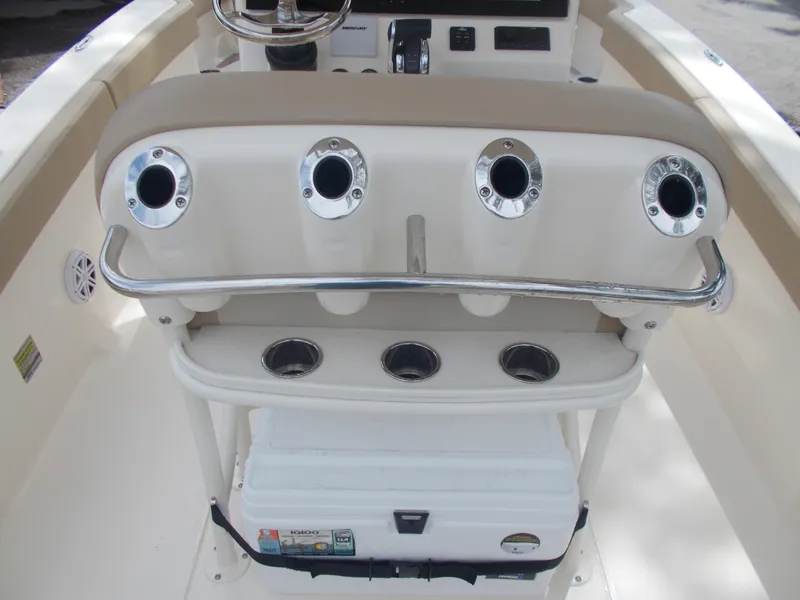 Slide: The Image of 2025 Scout 240 XSF boat console with rod holders and cooler. - 5