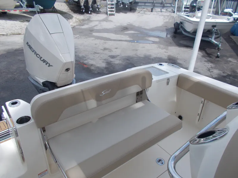 Slide: The Image of 2025 Scout 240 XSF boat with Mercury outboard engine and beige seating. - 6